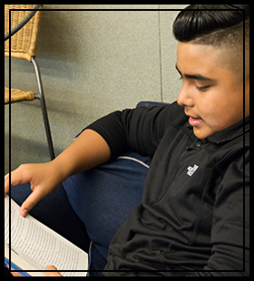 male student reading a book